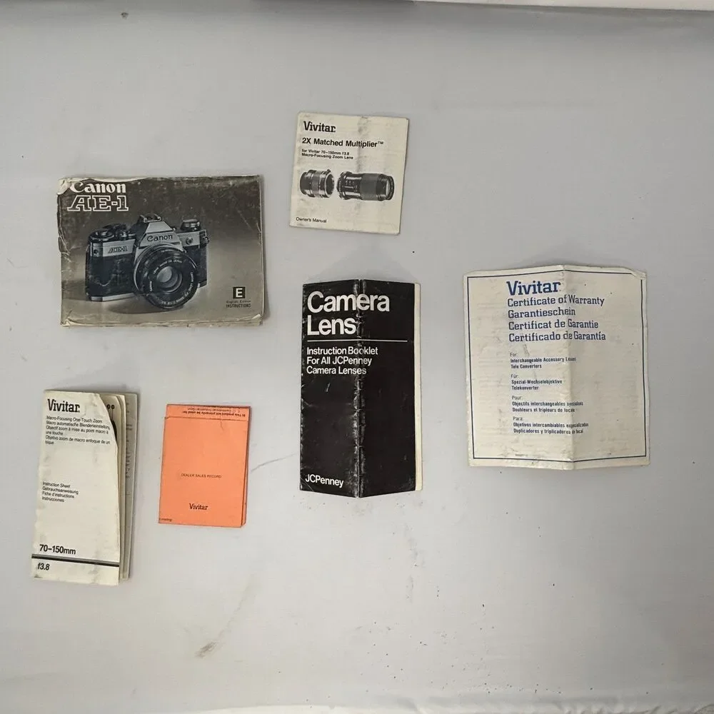 Canon AE-1 35mm SLR Film Camera W/ 2 Lens, Flash, Case, Paperwork UNTESTED